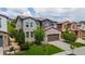 Charming two-story home featuring a stone garage facade and a well-maintained lawn, offering curb appeal at 2347 S Loveland St, Lakewood, CO 80228