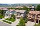 Beautiful two-story home with a stone facade garage, surrounded by lush greenery and neighborhood views at 2347 S Loveland St, Lakewood, CO 80228