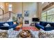 Elegant living room with a cozy fireplace, plush blue sofas, and tall ceilings, providing a comfortable retreat at 2347 S Loveland St, Lakewood, CO 80228