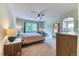 Bright main bedroom boasts a ceiling fan and plenty of natural light from a large window at 2347 S Loveland St, Lakewood, CO 80228