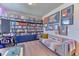 A well-lit home office space with custom shelving and a comfortable seating area at 2347 S Loveland St, Lakewood, CO 80228