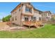 Exterior of a two-story home with a deck, yard and garden area, and neutral color scheme at 10695 Wynspire Rd, Highlands Ranch, CO 80130