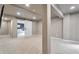 Spacious finished basement with modern lighting, gray walls, and a doorway with sliding barn door at 10695 Wynspire Rd, Highlands Ranch, CO 80130
