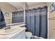 Classic bathroom with a toilet and a shower/tub combo with blue shower curtain at 10695 Wynspire Rd, Highlands Ranch, CO 80130