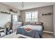Well lit bedroom with a window and bed with gray and orange bedding at 10695 Wynspire Rd, Highlands Ranch, CO 80130