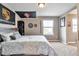 Comfortable bedroom with a large window, gray color scheme, and stylish decor at 10695 Wynspire Rd, Highlands Ranch, CO 80130