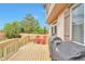 Wood deck area with a grill and red chairs with a view of the yard and a privacy fence at 10695 Wynspire Rd, Highlands Ranch, CO 80130