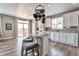 This eat-in kitchen has an island with bar stool seating, granite countertops, and a door to the deck at 10695 Wynspire Rd, Highlands Ranch, CO 80130