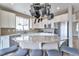 Bright eat-in kitchen with white cabinets, granite countertops, stainless steel appliances, and kitchen island at 10695 Wynspire Rd, Highlands Ranch, CO 80130
