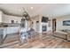 Open concept: The kitchen flows into the living room, featuring a gas fireplace with stone surround at 10695 Wynspire Rd, Highlands Ranch, CO 80130