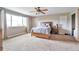Spacious main bedroom featuring a ceiling fan, large window, and comfortable furnishings at 10695 Wynspire Rd, Highlands Ranch, CO 80130