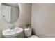 This half-bathroom features a modern sink, sleek faucet, and stylish oval mirror at 9836 Mount Kataka Pt, Littleton, CO 80125