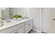 Bright bathroom featuring double sinks, a modern design, and stylish fixtures with ample counter space at 9836 Mount Kataka Pt, Littleton, CO 80125