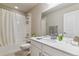 Clean bathroom featuring a shower and tub combination, a large mirror, and sleek white cabinets at 9836 Mount Kataka Pt, Littleton, CO 80125