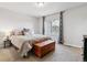 A cozy bedroom showcases a comfortable bed, window with view, and stylish curtains at 9836 Mount Kataka Pt, Littleton, CO 80125