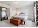 Bedroom featuring a comfortable bed, trunk, and ensuite bath that offers added convenience at 9836 Mount Kataka Pt, Littleton, CO 80125