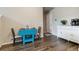Bright dining area features wood floors, a unique table, and a modern, minimalist design at 9836 Mount Kataka Pt, Littleton, CO 80125