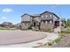 Attractive townhome with stone accents, siding, and a landscaped front yard at 9836 Mount Kataka Pt, Littleton, CO 80125