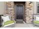Charming front entrance with decorative stonework and cozy seating at 9836 Mount Kataka Pt, Littleton, CO 80125