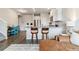 Stylish kitchen with island seating, stainless steel appliances, and hardwood floors at 9836 Mount Kataka Pt, Littleton, CO 80125