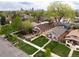 Aerial view of the neighborhood with tree-lined streets and well-maintained homes, and the skyline in the background at 3731 N Race St, Denver, CO 80205