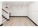 Finished basement area with light walls, a wine fridge, and vinyl floors at 3731 N Race St, Denver, CO 80205