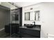Modern bathroom with black vanity, vessel sink, and glass-enclosed shower at 3731 N Race St, Denver, CO 80205