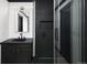 Bathroom featuring dark vanity, vessel sink, and glass-enclosed shower at 3731 N Race St, Denver, CO 80205