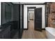 Modern bathroom with black-framed shower and black hexagon tile at 3731 N Race St, Denver, CO 80205