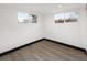 Bright bedroom featuring neutral walls and light wood flooring with two windows at 3731 N Race St, Denver, CO 80205