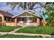 Charming brick home with a covered front porch, swing, and well-manicured lawn at 3731 N Race St, Denver, CO 80205