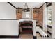 Hallway featuring custom shelving, hardwood floors, and brick accent wall at 3731 N Race St, Denver, CO 80205