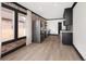 Spacious kitchen with stainless steel appliances, floating shelves and large windows at 3731 N Race St, Denver, CO 80205