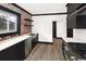 Modern kitchen featuring stainless steel appliances and brick accent wall at 3731 N Race St, Denver, CO 80205