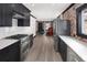 Open-concept kitchen with stainless steel appliances and view into the living room at 3731 N Race St, Denver, CO 80205
