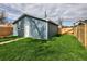 A blue outbuilding in the backyard, surrounded by grass and a wooden fence at 3731 N Race St, Denver, CO 80205