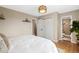 Bedroom with a full size bed, wood floors, closet and doorway leading to the bathroom at 17934 E Purdue Pl, Aurora, CO 80013