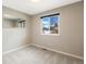 Cozy bedroom with neutral carpet, a large window, and a full-length mirror at 17934 E Purdue Pl, Aurora, CO 80013