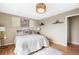 Bedroom with a full size bed, wood floors, shelves and paintings on the wall at 17934 E Purdue Pl, Aurora, CO 80013