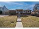 Charming single-story home featuring a brick facade, well-manicured lawn, and inviting front entrance at 17934 E Purdue Pl, Aurora, CO 80013