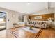 Well-lit living room showcasing hardwood floors, stylish furniture, and a modern accent wall at 17934 E Purdue Pl, Aurora, CO 80013