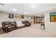 Spacious living room featuring plush seating, neutral walls, and a built-in entertainment center at 17934 E Purdue Pl, Aurora, CO 80013