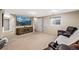 Neutral living room showcasing plush furniture, a large screen, and neutral carpet at 17934 E Purdue Pl, Aurora, CO 80013