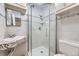 Bathroom featuring glass shower and updated tile at 7930 Poplar St, Commerce City, CO 80022