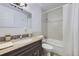 Updated bathroom with granite vanity, shower-tub, and tiled walls at 7930 Poplar St, Commerce City, CO 80022