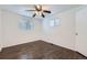 Bright bedroom with windows, ceiling fan, and hardwood floors at 7930 Poplar St, Commerce City, CO 80022
