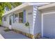 Side view of a charming house featuring blue shutters, stone accents, and a convenient attached garage at 7930 Poplar St, Commerce City, CO 80022
