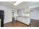 Well-lit kitchen with attractive flooring, cabinets, and updated countertops at 7930 Poplar St, Commerce City, CO 80022