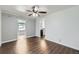 Modern living room with ceiling fan, sleek floors, and easy access to the kitchen at 7930 Poplar St, Commerce City, CO 80022