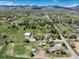 Expansive neighborhood with homes, trees, and mountains in the background at 10220 W Montgomery Ave, Littleton, CO 80127